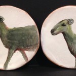Two earthenware goat decorative items.