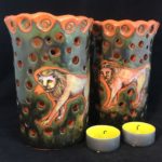 Two lion votive tea light holders.